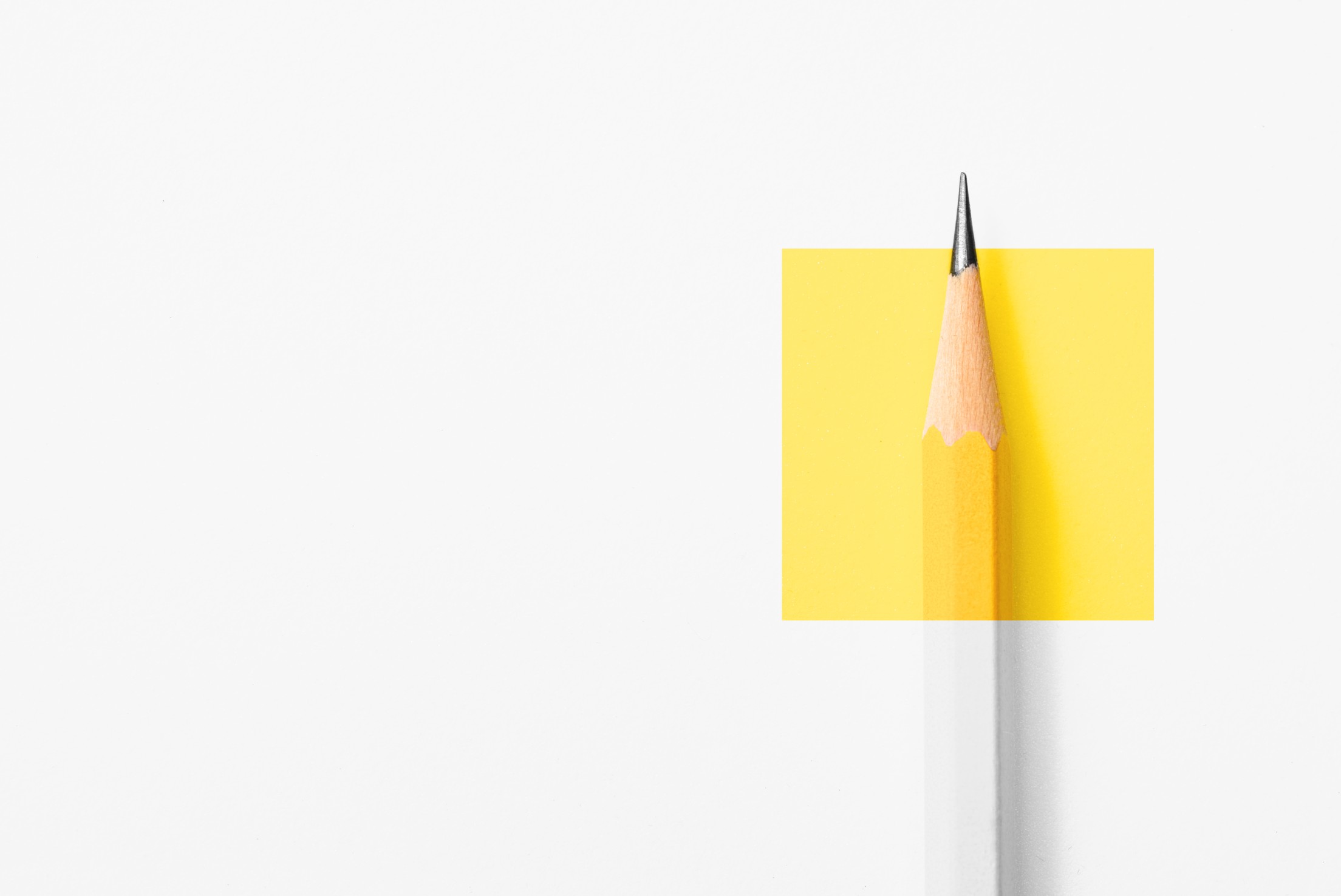 Minimalist design with white background with pencil on yellow square
